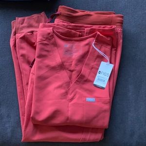 Figs scrubs. Never worn! Size large jogger, size large one pocket top. Coral